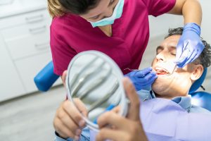 dental assistant cleaning teeth